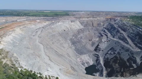 Aerial view of opencast mining quarry with lots of machinery at work - view from Stockbeeldmateriaal 103251879