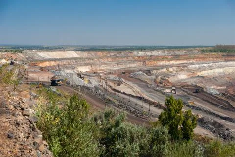 Aerial view of opencast mining quarry with lots of machinery at work. Stock Photos
