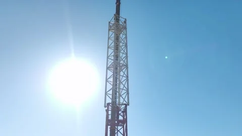 Aerial View: Operator assembles crane components and climbs gracefully against Stock Footage 296021122
