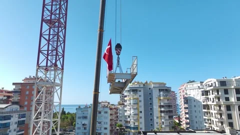 Aerial View: Operator assembles crane components with skill and climbs ladders Vídeo Stock 296419018