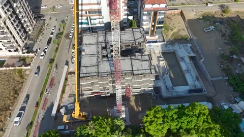 Aerial View: Operator climbs high ladders and mounts crane parts with skill Vídeo Stock 296025410