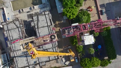 Aerial View: Operator climbs ladders smoothly, assembling parts and working Vídeo Stock 296026172