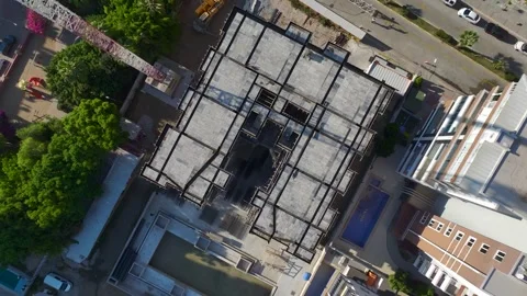 Aerial View: Operator climbs tall ladders to mount parts precisely, working Vídeo Stock 296025490