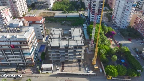 Aerial View: Operator climbs tall ladders with care, mounting crane components Stock Footage 296025726