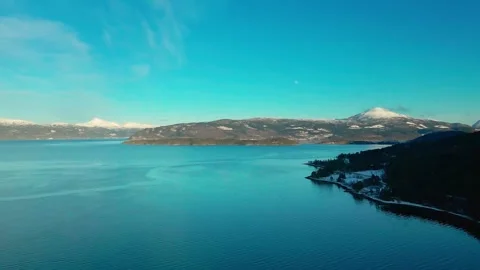Aerial View of Oppdal, Norway, Tranquil Lake and Snow Capped Mountains at Sunris Stock Footage 315736829