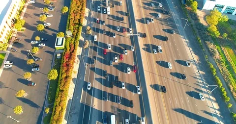 Aerial view or drone shot from above over a busy freeway with cars below Stock Footage 107888545
