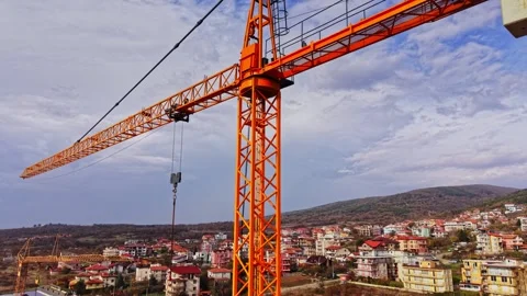Aerial view of an orange construction crane against a blue sky Stock Footage 324523381