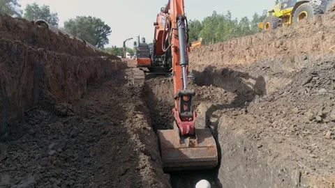 Aerial view of orange or red excavator tractor digging the sand ground to laying Stock Footage 131014088