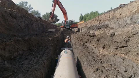 Aerial view of orange or red excavator tractor digging the sand ground to laying Stock Footage 131015672