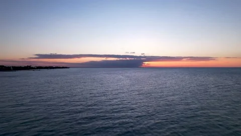 Aerial view of orange sunset. Drone flying over ocean on Holbox Island in Mexico Stock Footage 230081309