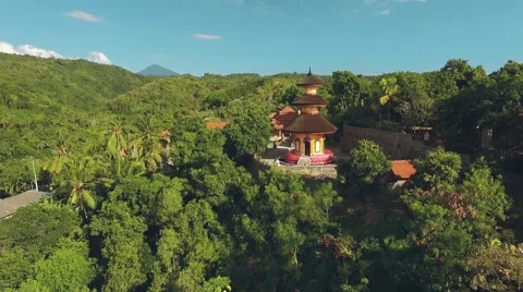Aerial view of orange temple tower on green hill, Brahma Vihara Arama Monastery 動画素材 68084183
