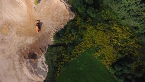 Aerial view at orange wheel loader transports sand in a sand quarry Stock Footage 163375161