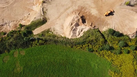 Aerial view at orange wheel loader transports sand in a sand quarry Stock Footage 163375518