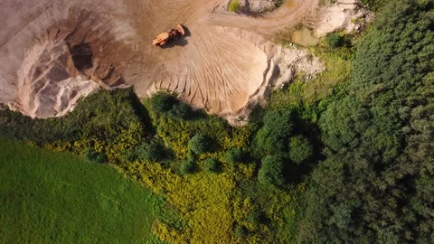 Aerial view at orange wheel loader transports sand in a sand quarry Stock Footage 163375645