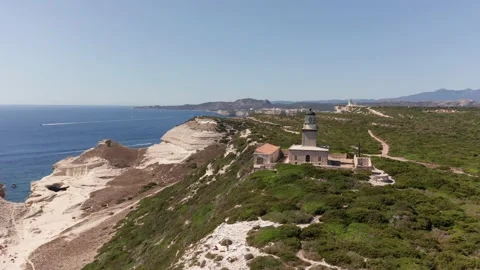 Aerial view orbit of lighthouse on the top of cliff in a sunny summer day 動画素材 157629456