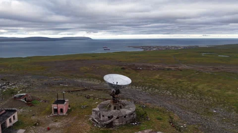 Aerial view of Orbita parabolic dish and coastline under dramatic cloud Vídeos de archivo 326595777
