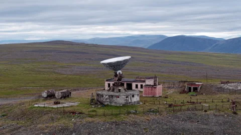 Aerial view of Orbita satellite dish dominating the Arctic hillside near Lavrent Stock Footage 327122811