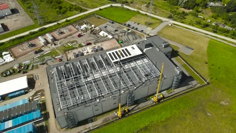 Aerial view orbiting around a large data center building under construction Stock Footage 343934574