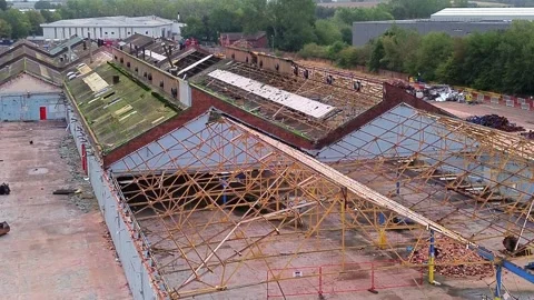 Aerial view orbiting former Glen Dimplex site warehouse framework demolition Stock Footage 345406280