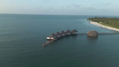 Aerial view orbiting luxurious thatched roof Kae Funk vacation lodges Stock Footage 276342587