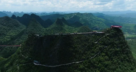 Aerial view orbiting the Ruyi cloud top platform surrounded by karst mountains Stock Footage 345392691