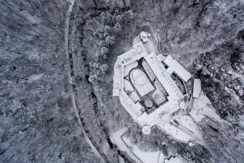 Aerial view of an ortodox monastery in the middle of a snowy forest Stock Photos
