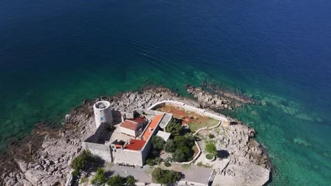 Aerial view of Otocic Gospa showcasing its stunning coastal landscape and Stock Footage 287786843