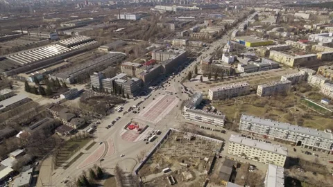 Aerial view of oval square in a city with low buildings and factory Stock Footage 287673362