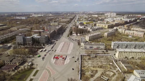 Aerial view of oval square in a city with low buildings and factory Stock Footage 287680731