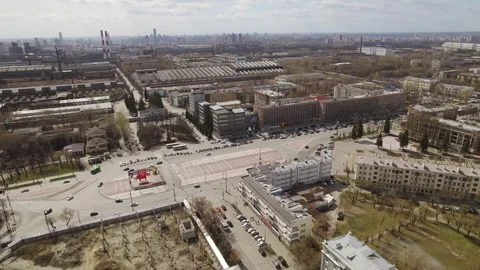 Aerial view of oval square in a city with low buildings and factory Stock Footage 287680908