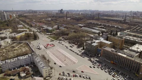 Aerial view of oval square in a city with low buildings and factory Stock Footage 287681983