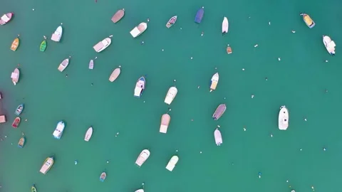 Aerial view over a bay with turquoise water with many small fishing boats Video stock 228683083