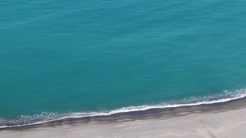 An Aerial View Over a Beautiful Beach, Overlooking the Ocean Waves and Water. Stock Footage 236287913