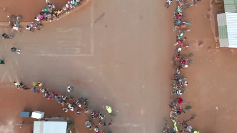 Aerial view over bicycle spinners entertaining spectators at a street corner Stock Footage 239449287