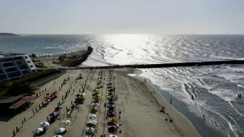 Aerial view over the Bocagrande beach, towards paragliders on the sea in Stock Footage 236896017