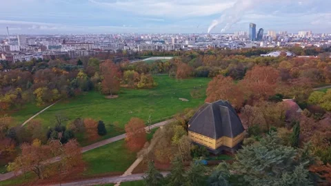Aerial View Over Bois de Vincennes With Autumn Trees and Paris Skyline Stock Footage 323907904
