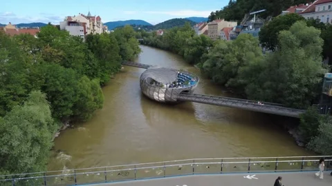 Aerial view over bridge toward Murinsel island, Graz, Austria 库存影片 338294529