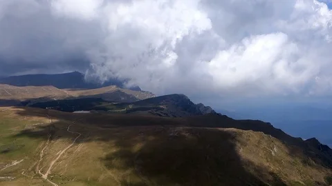 Aerial view over Bucegi mountain clouds running over Stock Footage 102887399