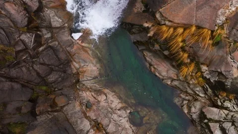 Aerial View Over Cascade Between Big Rocks During Daytime Stock Footage 302083222