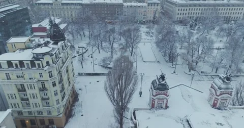Aerial view over the center of Sofia with snowy architectural buildings and park 스톡 동영상 297779898