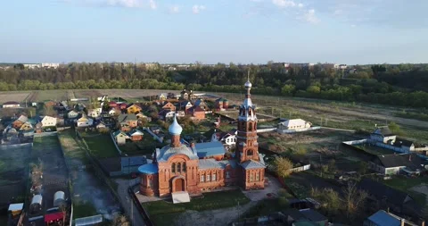 Aerial view over chuch in small town. Around view. Stock Footage 151729760