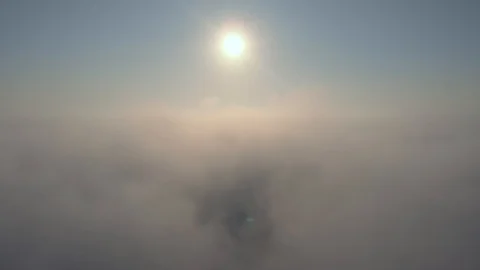 Aerial view over the clouds and sun is shining. Drone flying above clouds Stock Footage 97599851