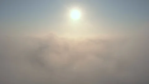 Aerial view over the clouds and sun is shining. Drone flying above clouds Stock Footage 97599959