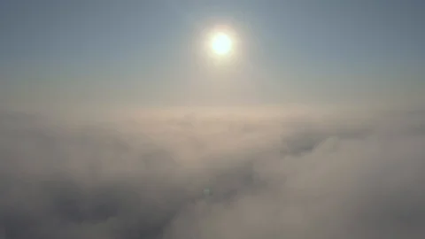 Aerial view over the clouds and sun is shining. Drone flying above clouds Stock Footage 97600074