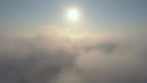 Aerial view over the clouds and sun is shining. Drone flying above clouds Stock Footage 97600169