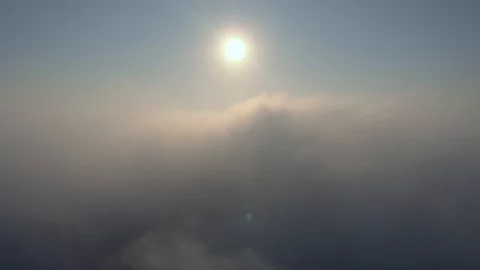 Aerial view over the clouds and sun is shining. Drone flying above clouds Stock Footage 97600274