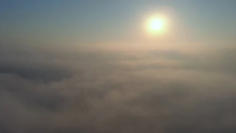 Aerial view over the clouds and sun is shining. Drone flying above clouds Stock Footage 97600532