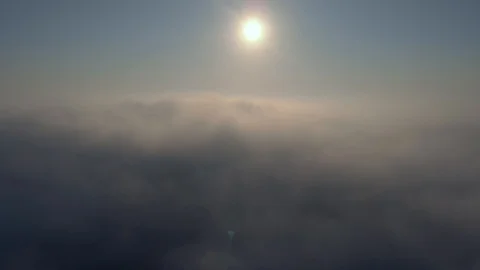 Aerial view over the clouds and sun is shining. Drone flying above clouds Stock Footage 97600564