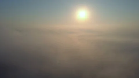 Aerial view over the clouds and sun is shining. Drone flying above clouds Stock Footage 97600606