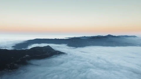 Aerial view over clouds and majestic mountains at sunrise (Malibu Canyon Stock Footage 126678621